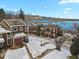 Beautiful exterior view of townhomes with lake views and snowy landscaping on a bright sunny day at 14585 W 32Nd Ave, Golden, CO 80401