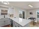 Kitchen area showcasing an island with a sink, quartz countertops, and stainless steel appliances at 14585 W 32Nd Ave, Golden, CO 80401