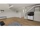 Bright and modern living room with wood floors and a sleek staircase with black railing and white walls at 14585 W 32Nd Ave, Golden, CO 80401