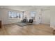 Bright living room with light wood floors, white walls, and large windows, creating an inviting space at 14585 W 32Nd Ave, Golden, CO 80401