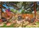 Inviting backyard with stone fire pit and charming wicker seating area, perfect for entertaining at 2237 Zinnia St, Golden, CO 80401