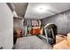 Unfinished basement area perfect for storage or a home gym, with clothing rack and treadmill at 2237 Zinnia St, Golden, CO 80401