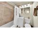 Bathroom features a shower-tub combination with decorative curtain and a white vanity at 2237 Zinnia St, Golden, CO 80401
