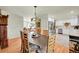 Open-concept dining area with wood table and chairs, adjacent to the kitchen and living space at 2237 Zinnia St, Golden, CO 80401