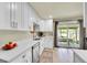 Bright kitchen with white cabinets, stainless steel appliances, and a view to the patio at 2237 Zinnia St, Golden, CO 80401