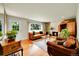 Cozy living room features a stone fireplace, hardwood floors, and comfortable seating at 2237 Zinnia St, Golden, CO 80401