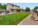 Spacious backyard with lush green grass, privacy fence, and a shed at 14057 E Arkansas Pl, Aurora, CO 80012