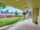Spacious backyard featuring a covered patio and well-maintained lawn, perfect for outdoor entertaining at 14057 E Arkansas Pl, Aurora, CO 80012