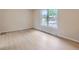 Neutral bedroom featuring a large window and light wood-look floors at 14057 E Arkansas Pl, Aurora, CO 80012