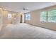 Bright bedroom featuring plush carpeting, ceiling fan and ensuite bathroom with dual-sink vanity at 14057 E Arkansas Pl, Aurora, CO 80012