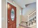 Inviting entryway with a decorative wood door, new stairs, and clean flooring at 14057 E Arkansas Pl, Aurora, CO 80012