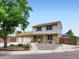 Charming two-story home with a well-maintained lawn, mature tree and a two car garage at 14057 E Arkansas Pl, Aurora, CO 80012