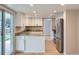 Updated kitchen featuring stainless steel appliances, granite countertops, and light colored cabinetry at 14057 E Arkansas Pl, Aurora, CO 80012