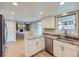Bright kitchen featuring granite countertops, stainless steel appliances, and white cabinets at 14057 E Arkansas Pl, Aurora, CO 80012