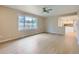 Bright living room with large window, modern ceiling fan, and access to the updated kitchen at 14057 E Arkansas Pl, Aurora, CO 80012
