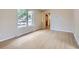 Bright living room features light wood-look floors and a large window at 14057 E Arkansas Pl, Aurora, CO 80012