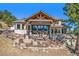 Picturesque outdoor patio area with stone accents, comfortable seating, and mountain views, perfect for entertaining at 32569 El Diente Ct, Evergreen, CO 80439