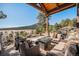 Cozy outdoor patio space with comfortable seating arrangements and scenic mountain views, ideal for relaxation at 32569 El Diente Ct, Evergreen, CO 80439