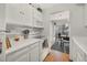 Updated kitchen with white cabinets, modern appliances, and adjacent dining area with sliding door to outdoor patio at 2557 S Dover St # 68, Lakewood, CO 80227