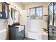 Charming bathroom features a farmhouse sink, and a window over the tub offering natural light at 11689 Caribou Dr, Franktown, CO 80116