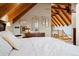 Bright bedroom with vaulted ceiling, natural light, and decorative decor on display at 11689 Caribou Dr, Franktown, CO 80116