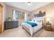Bright bedroom offering two windows, soft carpet, and a large painting on the wall at 11689 Caribou Dr, Franktown, CO 80116