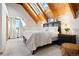 This bedroom offers vaulted ceilings, skylights, light carpet, and bright natural light at 11689 Caribou Dr, Franktown, CO 80116