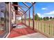 Inviting deck with wood floors, rustic pergola and railing offers outdoor seating and scenic views at 11689 Caribou Dr, Franktown, CO 80116