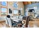 Open dining room with large windows, stone fireplace, and comfortable seating for memorable Gathering meals at 11689 Caribou Dr, Franktown, CO 80116