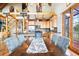 Open-concept dining room connects to kitchen, featuring a large table, comfortable seating, and ample natural light at 11689 Caribou Dr, Franktown, CO 80116