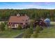 Stunning exterior view of home with mature trees and well-maintained landscaping at 11689 Caribou Dr, Franktown, CO 80116