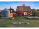 Scenic view of home's exterior, complete with a charming pond and lush greenery at 11689 Caribou Dr, Franktown, CO 80116