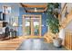 Inviting foyer featuring tile flooring, wooden accents, and a staircase to upper level of home at 11689 Caribou Dr, Franktown, CO 80116