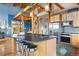 Kitchen features large center island with seating, stainless steel appliances, and open access to other living spaces at 11689 Caribou Dr, Franktown, CO 80116