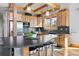 Kitchen boasts a large center island with seating, stainless steel appliances and natural light from the windows at 11689 Caribou Dr, Franktown, CO 80116