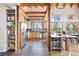 Open kitchen design features light wood cabinets, stainless steel appliances, and a large island with bar seating at 11689 Caribou Dr, Franktown, CO 80116