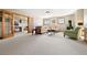 Spacious living room with neutral carpet, a comfortable seating area, and access to a separate office at 11689 Caribou Dr, Franktown, CO 80116