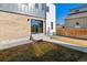 Backyard patio featuring stone steps and a modern glass door to the home's interior at 3432 W 25Th Ave, Denver, CO 80211