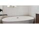Elegant bathroom with a freestanding soaking tub and patterned wall tiles, providing a spa-like experience at 3432 W 25Th Ave, Denver, CO 80211