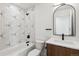 Modern bathroom featuring geometric tile accent wall, black fixtures, and a stylish vanity at 3432 W 25Th Ave, Denver, CO 80211