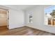 Spacious bedroom with wood flooring and ample natural light from multiple windows at 3432 W 25Th Ave, Denver, CO 80211