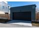Two-car detached garage with a modern design, providing secure parking and additional storage at 3432 W 25Th Ave, Denver, CO 80211