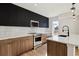 Well-lit kitchen with stainless steel appliances, modern cabinetry, and a functional layout at 3432 W 25Th Ave, Denver, CO 80211