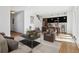 Open-concept living room with modern decor, hardwood floors, and abundant natural light from windows at 3432 W 25Th Ave, Denver, CO 80211