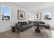 Cozy living room with large sectional sofa, modern artwork, and natural light from multiple windows at 3432 W 25Th Ave, Denver, CO 80211