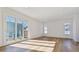 Bright and airy living space featuring hardwood floors, multiple windows, and a sliding glass door at 3432 W 25Th Ave, Denver, CO 80211