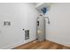 Utility room area with wood flooring and modern water heater at 3432 W 25Th Ave, Denver, CO 80211