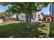 Spacious backyard featuring mature trees, well maintained lawn, and patio area for outdoor entertainment at 19917 Mitchell Cir, Denver, CO 80249
