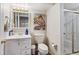Bright bathroom with a white vanity, decorative art, and glass shower enclosure at 19917 Mitchell Cir, Denver, CO 80249