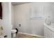 Bright bathroom featuring a ceramic tiled tub and shower, vinyl wood-look floor, and white cabinets at 19917 Mitchell Cir, Denver, CO 80249
